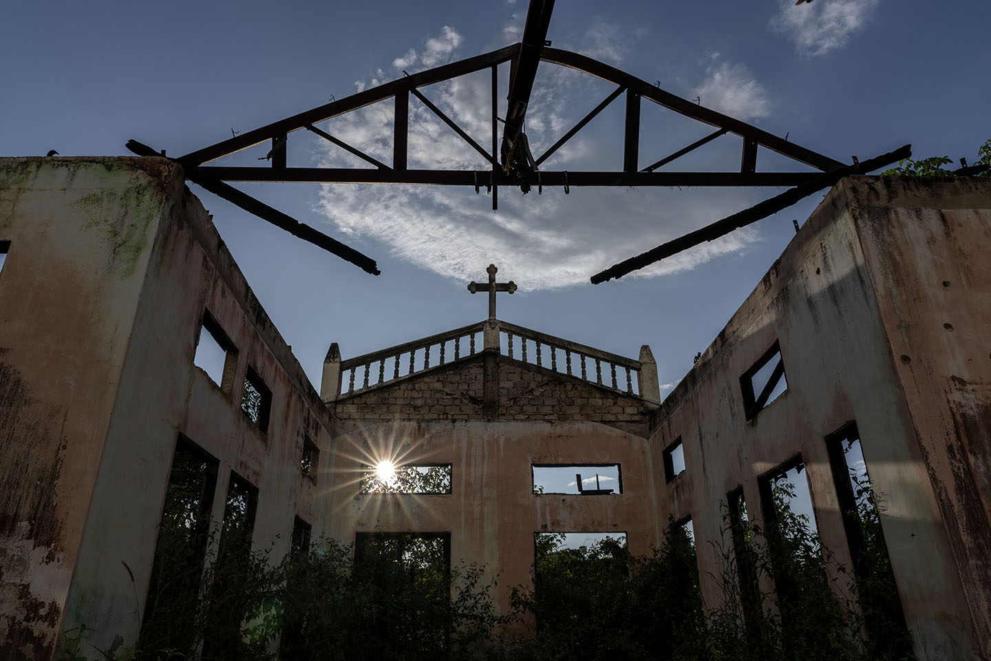 Sun shines through broken window of dilapidated church