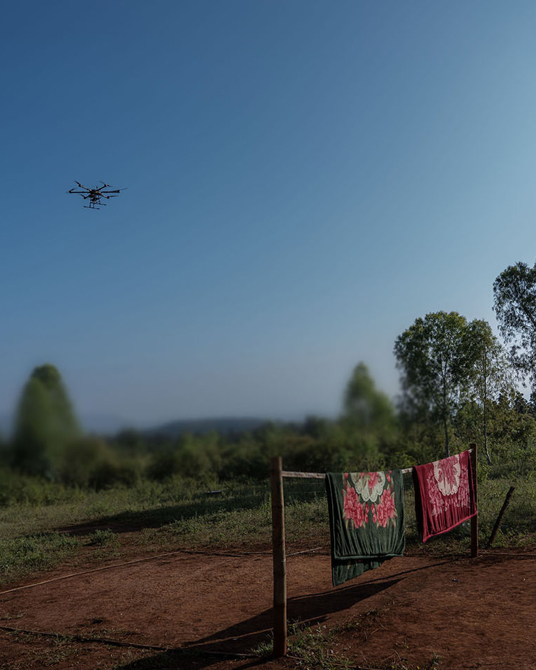 A drone flies in a blue sky with no clouds