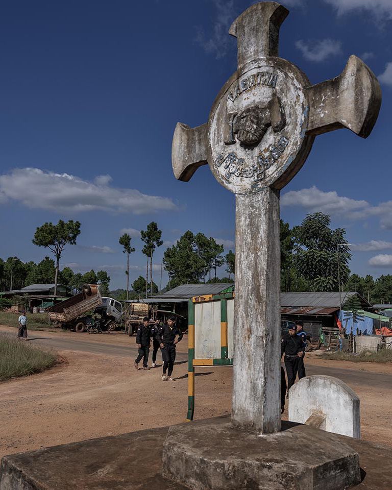 A large cross is pictured in front of a checkpoint