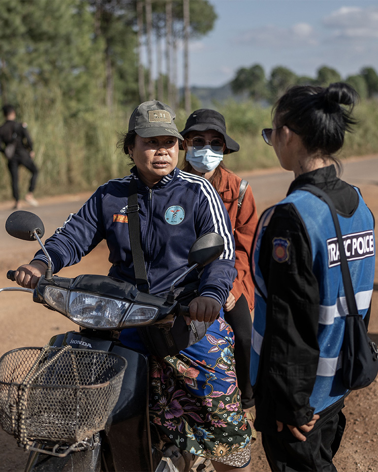 A female officer talks to a woman on a motorbike