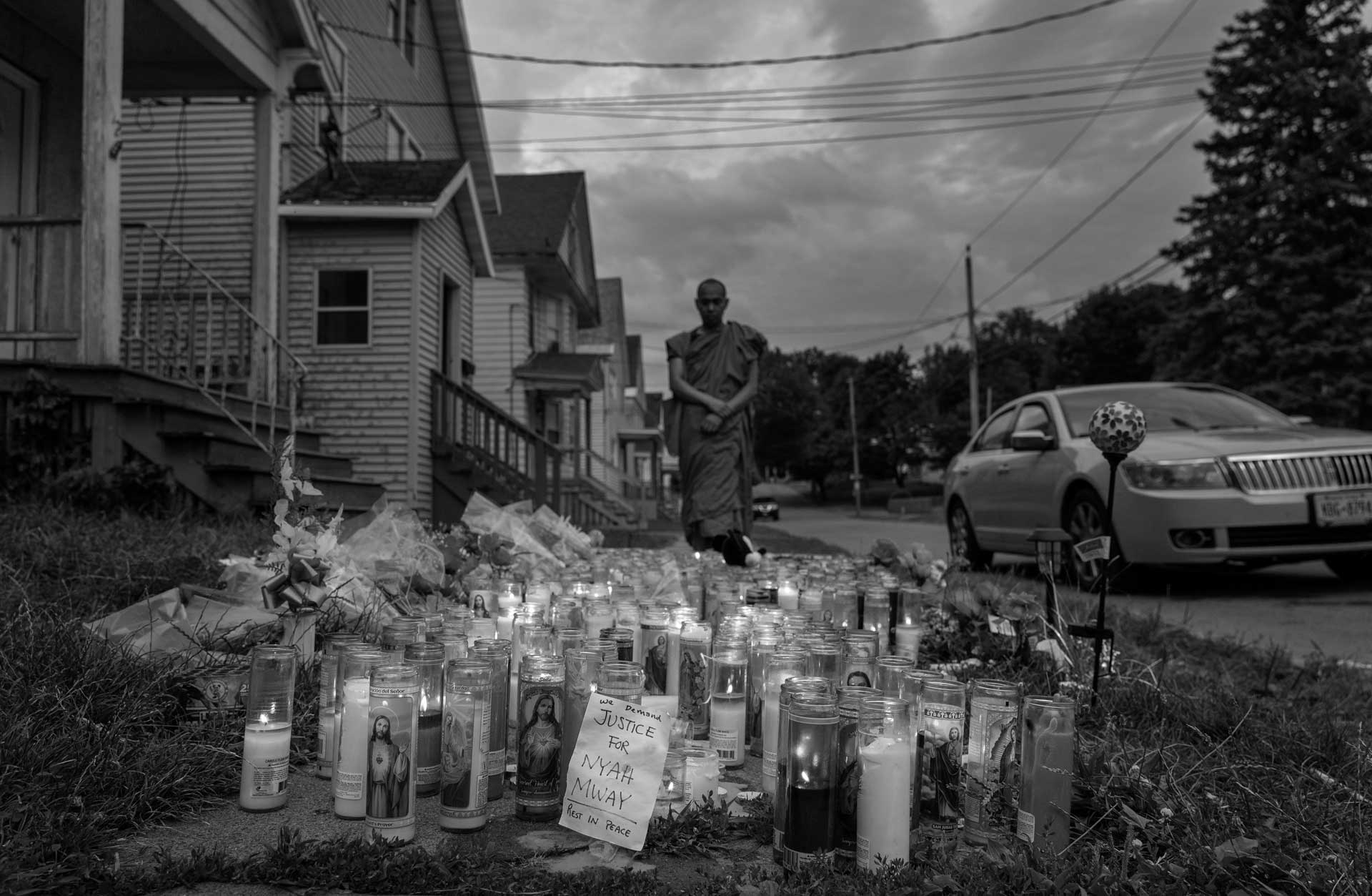 Pyin Nyein Da, a Karen Buddhist monk, looks at a memorial erected at the site of Nyah Mway’s shooting in Utica, New York, July 5, 2024.