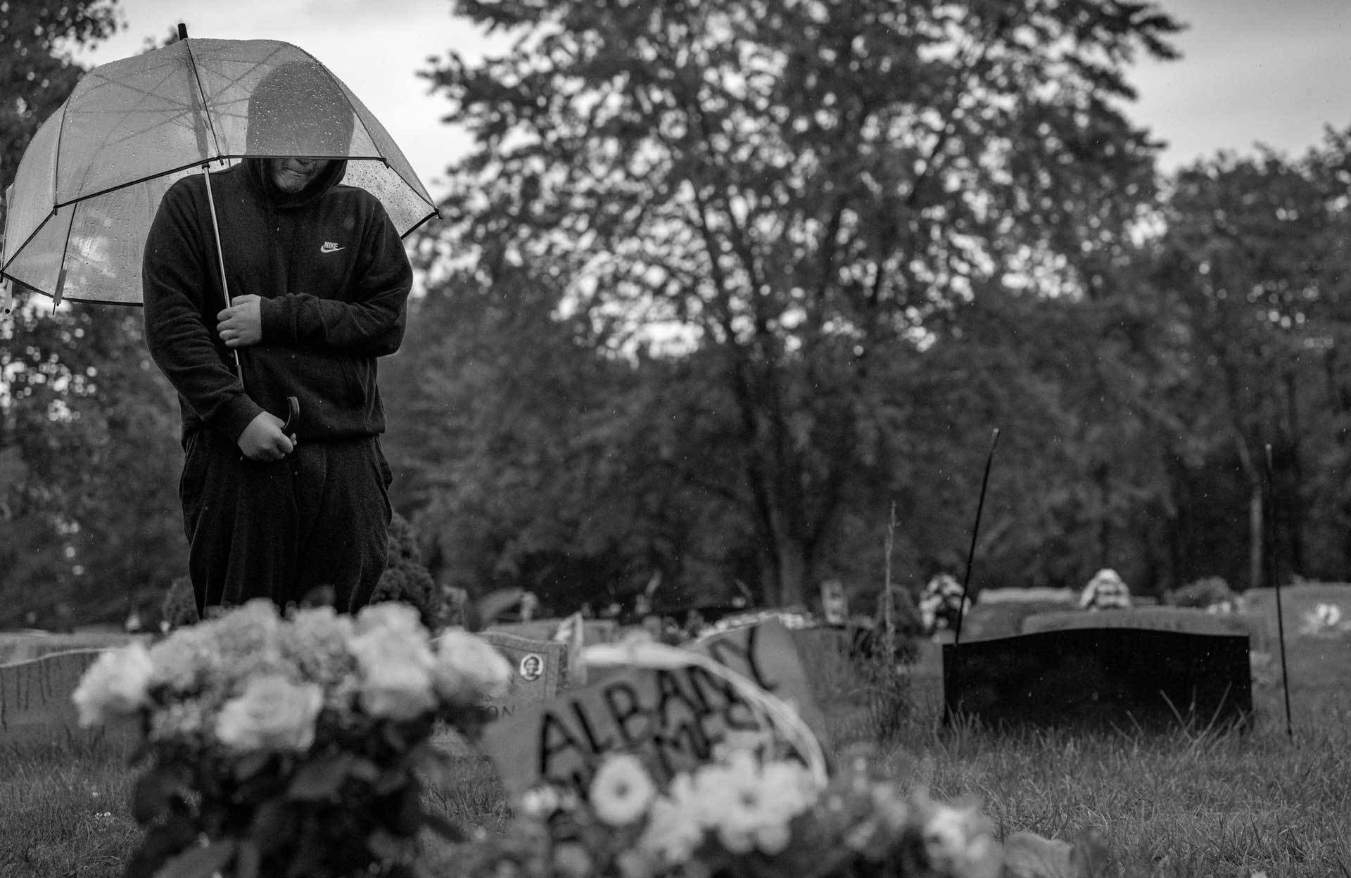 Nyah Mway’s cousin Met Ka Pur Soe visits his grave in Utica, New York, Aug. 18, 2024.