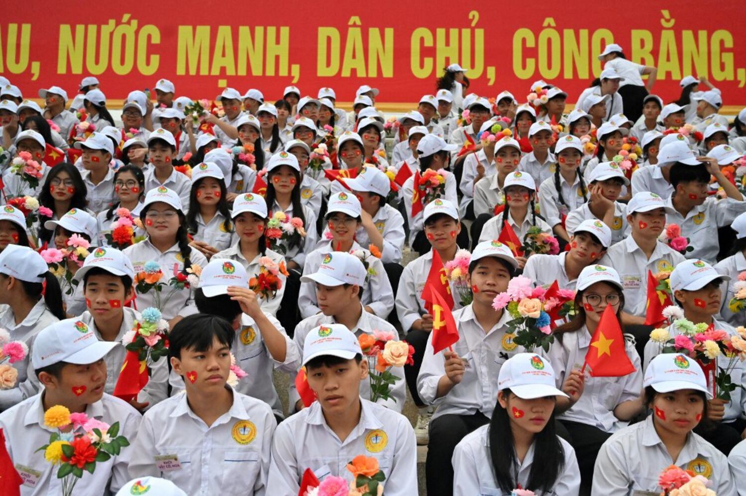 Students sit inside a stadium ahead of celebrations of the 70th anniversary of the 1954 Dien Bien Phu victory over French colonial forces in Dien Bien Phu city on May 7, 2024. (Nhac Nguyen/AFP)